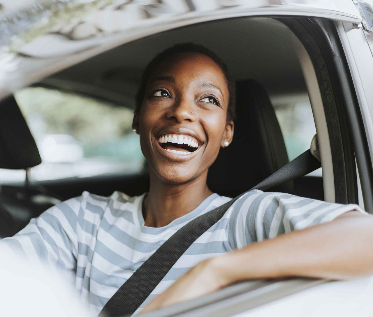 Happy woman driving a car