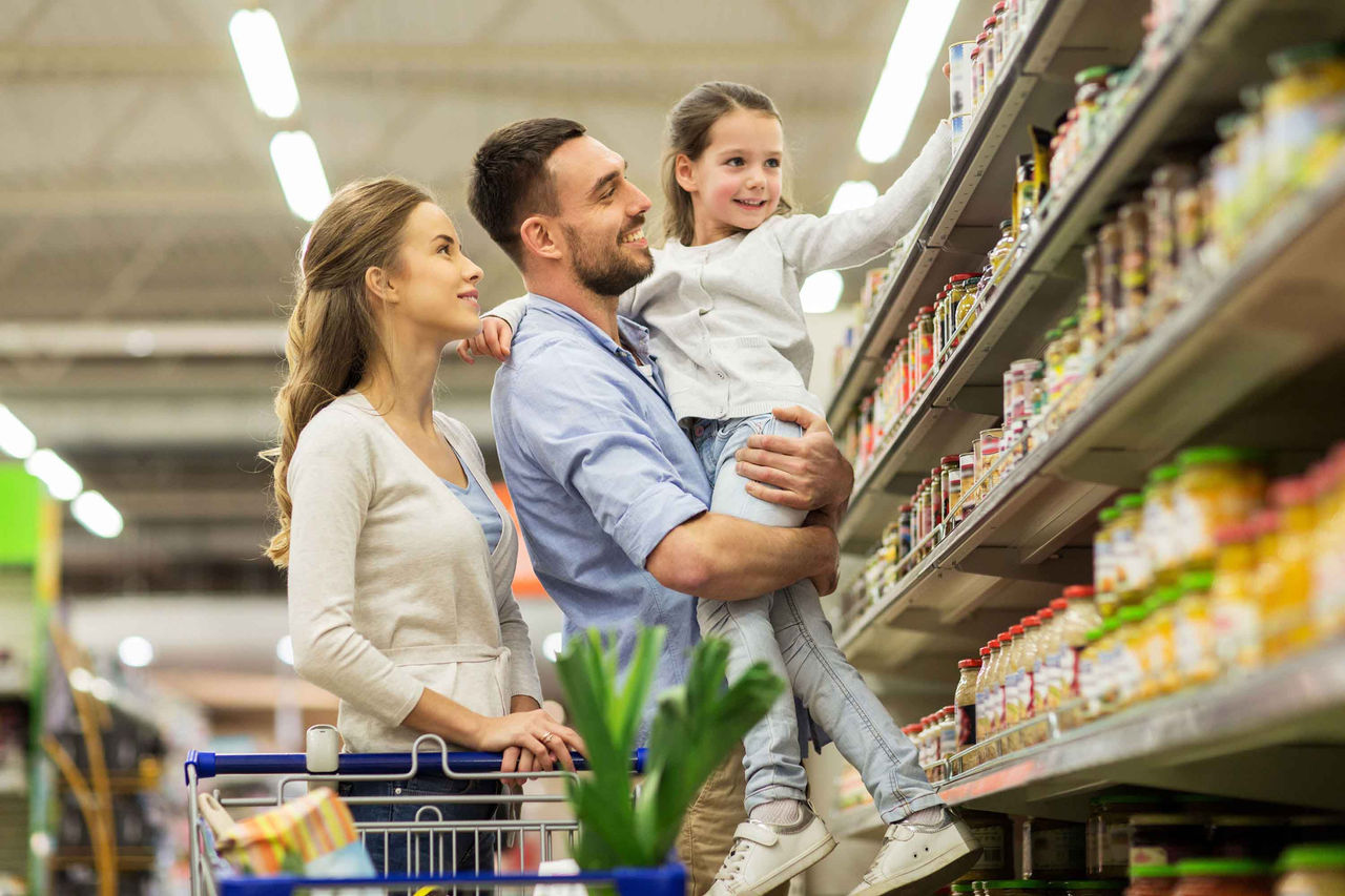 family with food in shopping cart at grocery store